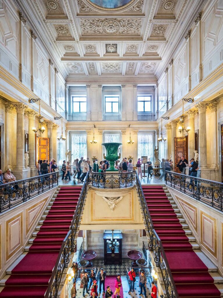 The interior of the Hermitage Museum in Saint Petersburg with stairs and a red carpet is truly cultural trip is a stunning cultural sight to behold.