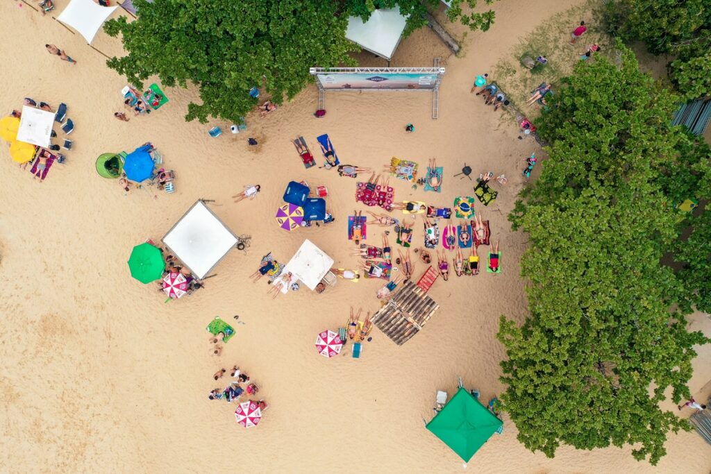 Aerial view of a beach with people and umbrellas.