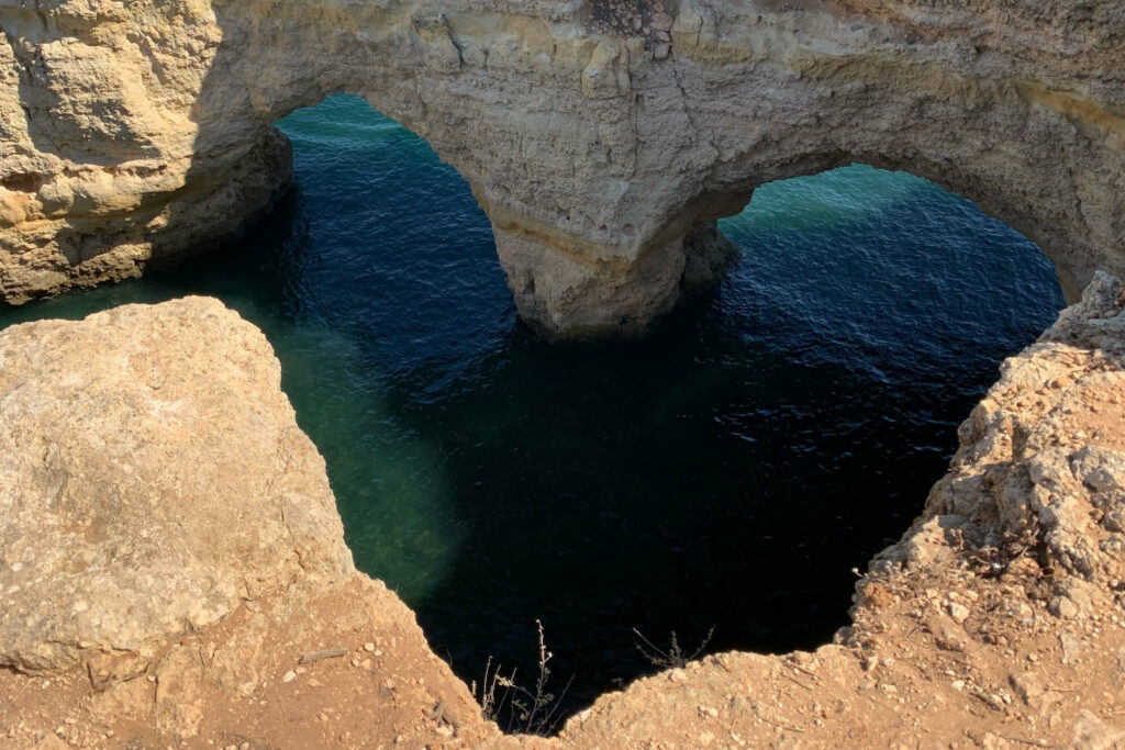 A photo showing a heart shaped opening of a cave in Benagil, Portimao, Portugal.