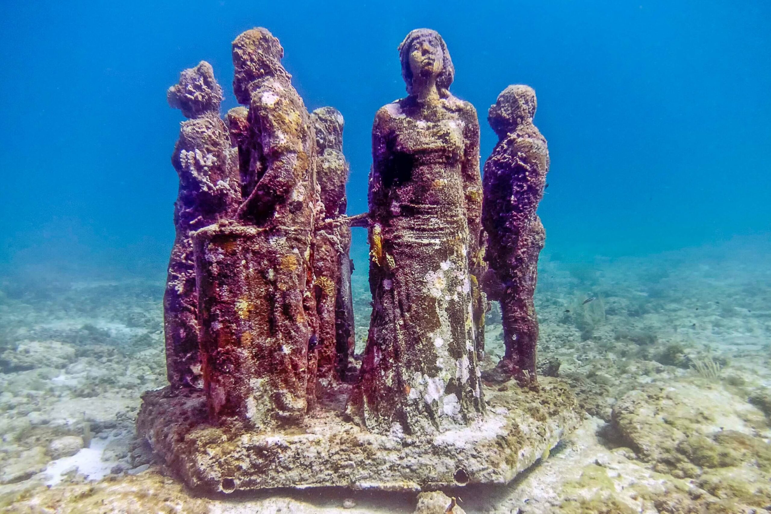 A cluster of statues on a coral reef in the Cancun underwater museum offers a unique opportunity for underwater exploration during your holiday.