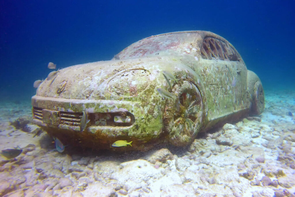 A photo of a submerged car at the Cancun underwater museum, (MUSA).