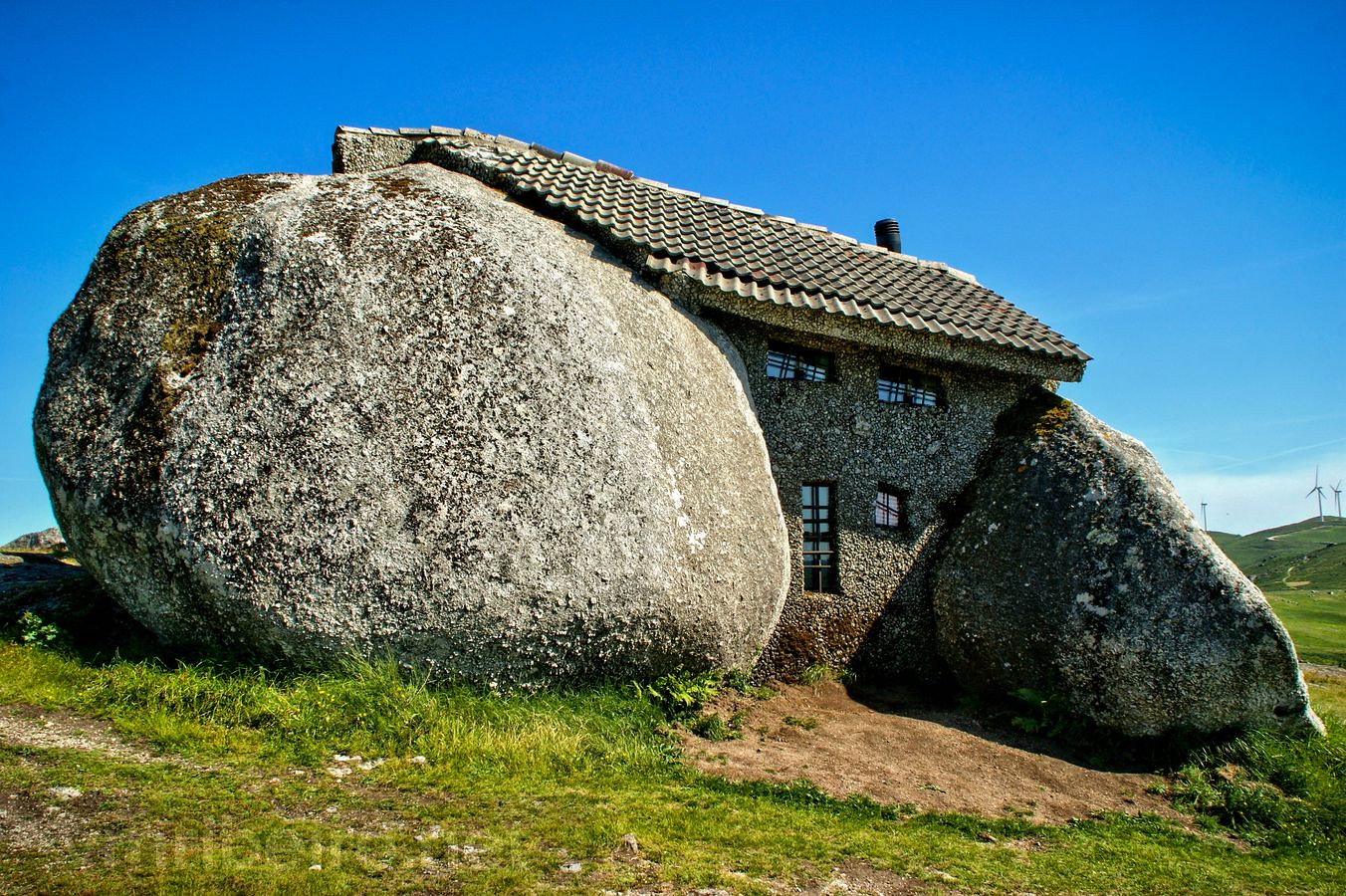 house built amongs two huge rocks
