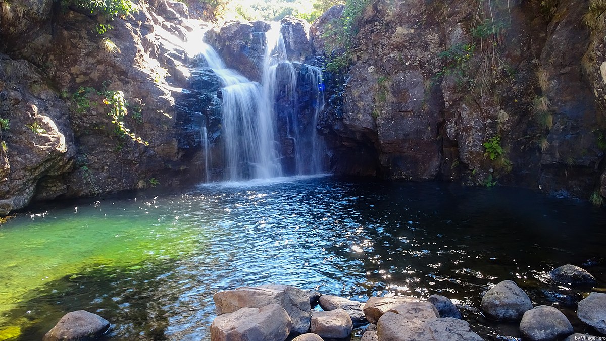 Explore Portugal's breathtaking waterfall nestled in a rocky landscape.