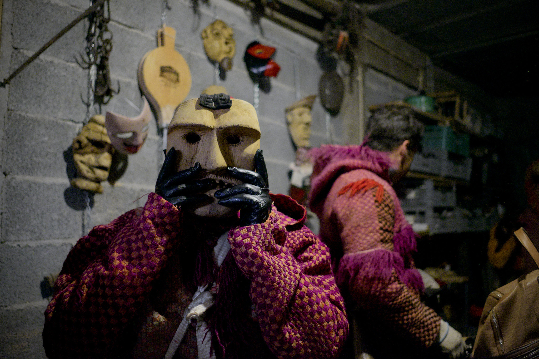 Careto mask, person using a  mask of the devil made out of wood