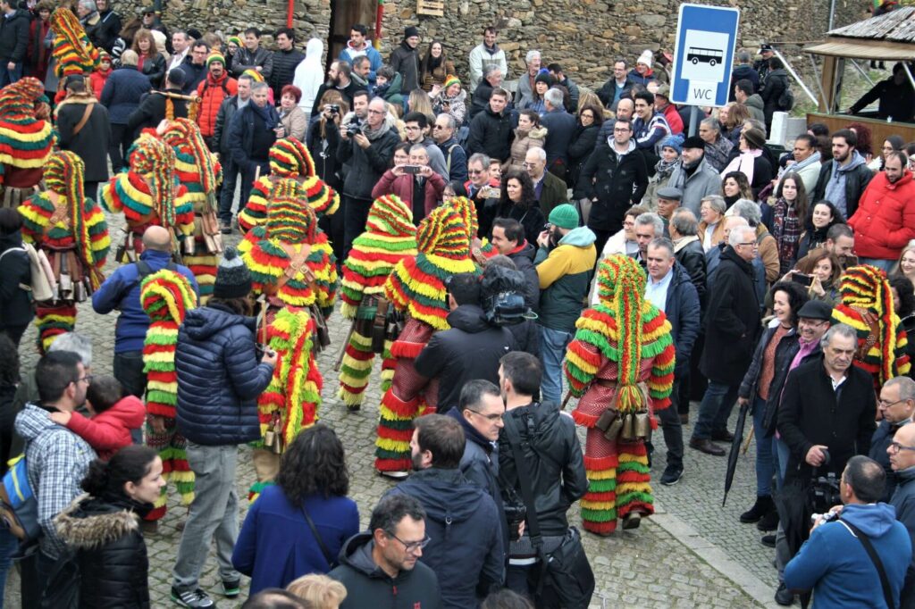 traditional pagan festival, men dressed up with colorful and vibrant costumes, holding bells