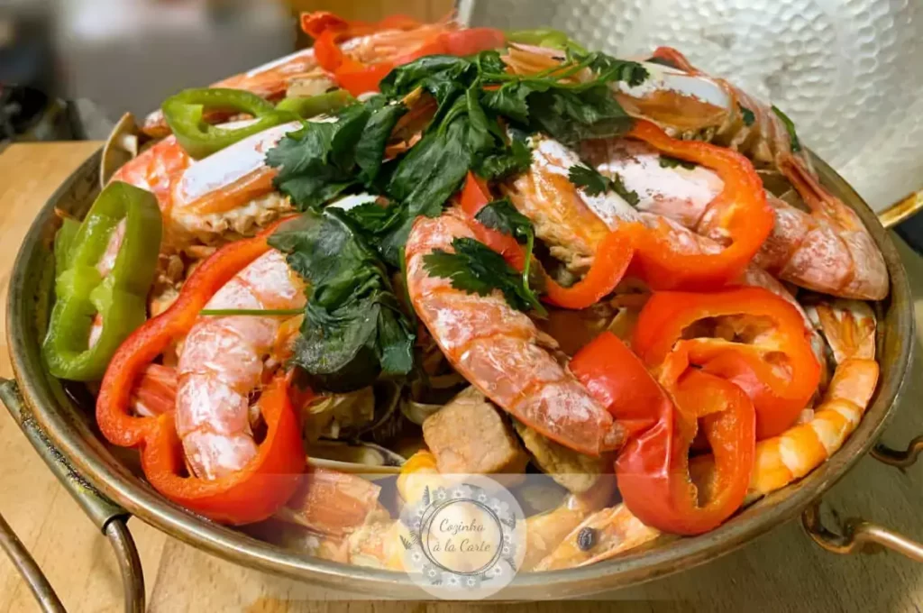 mixture of vegetables, spices, herbs and shrimps served on a frying pan