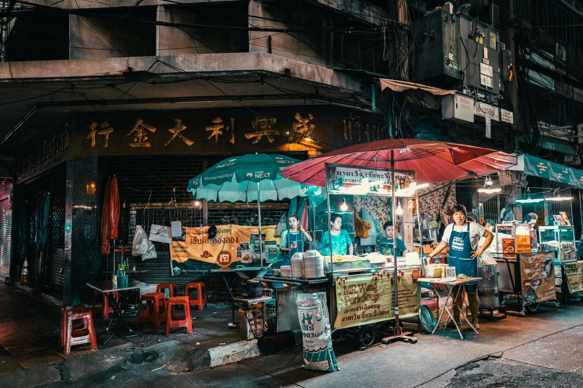 stalls in a food market in Thailand during nighttime