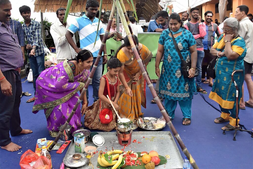 indiam families offering food in a ritual to honour the sun god