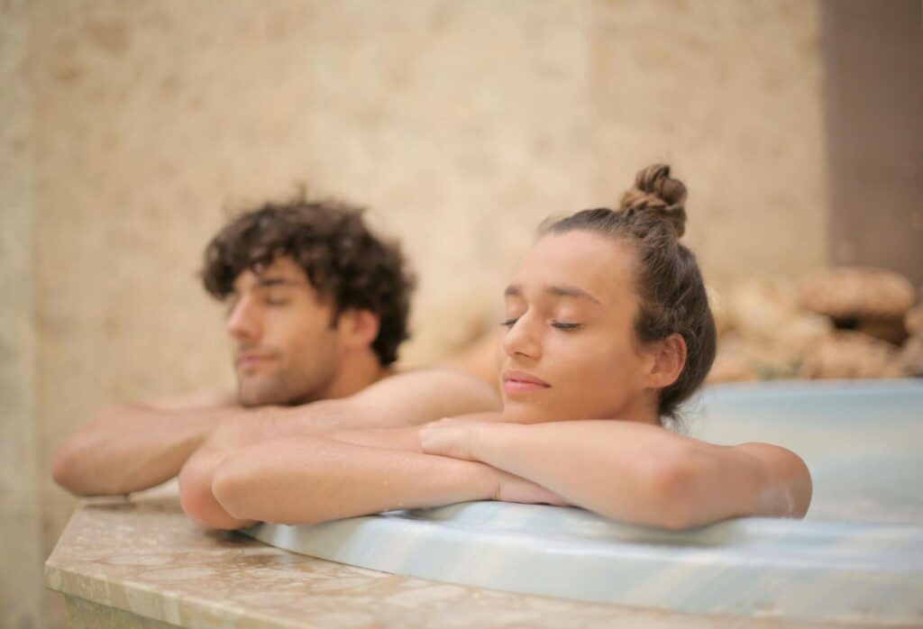 couple relaxing in a hot bath tube